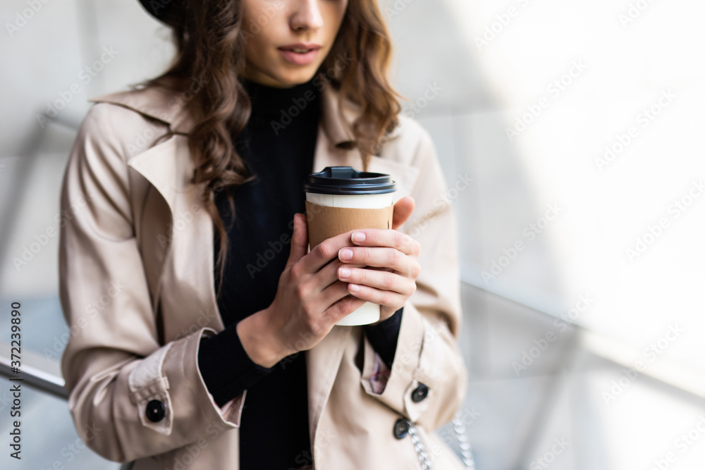 Shopping day. Coffee break. Attractive young woman with paper bags walking on city street. Shopping day. Coffee break. Attractive young woman with paper bags walking on city street.