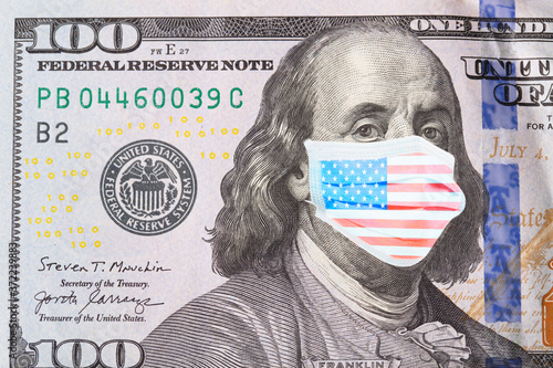 Benjamin Franklin masked in American flag colors on 100 dollar bill, isolated on white background. The concept of preventing money from the crisis.