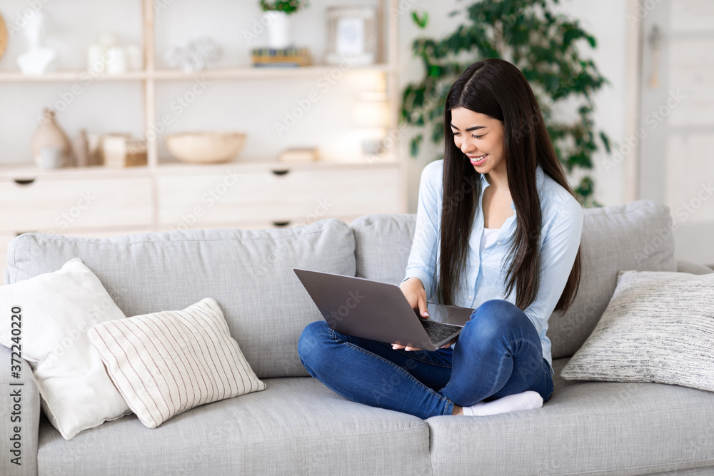 Online Education. Asian girl using laptop at home, having distance learning Online Education. Asian girl using laptop at home, having distance learning