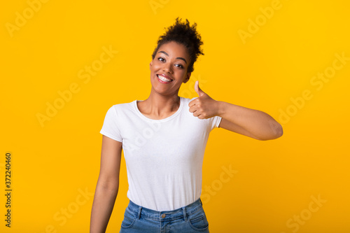 Afro woman showing thumb up and smiling © Prostock-studio
