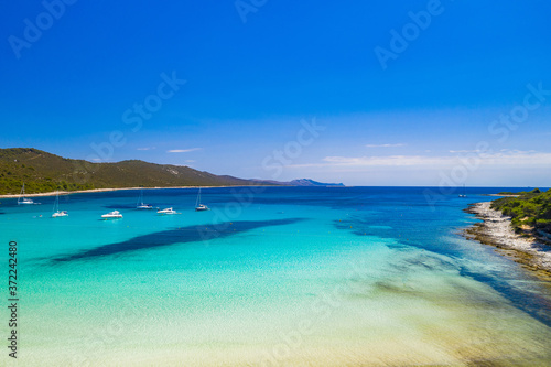 Amazing Adriatic coastline in Croatia. Azure turquoise lagoon on Sakarun beach on Dugi Otok island, yachts and sailboats anchored in blue sea.