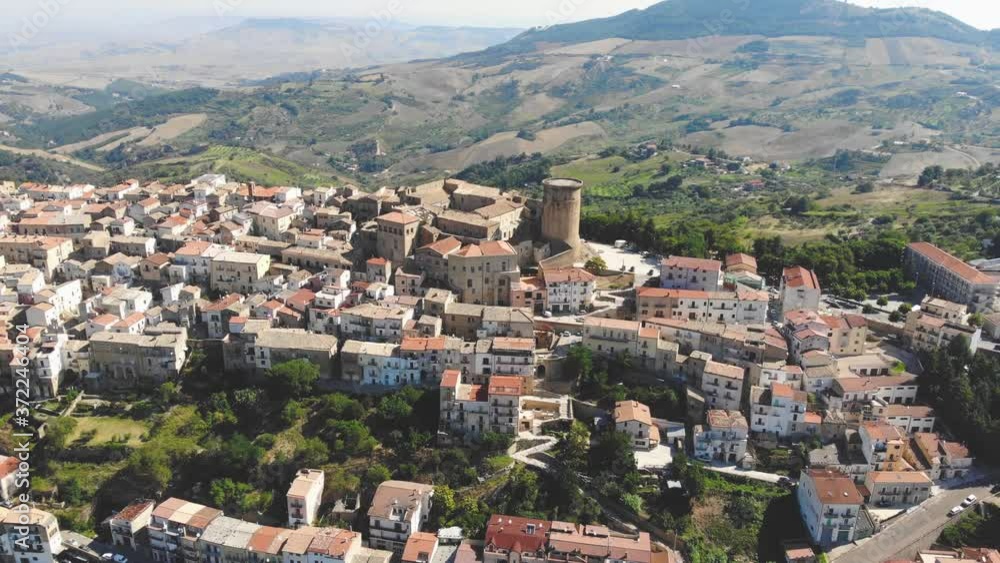 Tricarico town, province of Matera, Basilicata, southern Italy. It is home to one of the best preserved medieval historical centres in Italy. aerial view of tricarico with its Norman tower Tricarico town, province of Matera, Basilicata, southern Italy. It is home to one of the best preserved medieval historical centres in Italy. aerial view of tricarico with its Norman tower