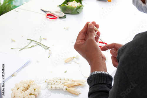 Hand-making flower garlands in Thailand