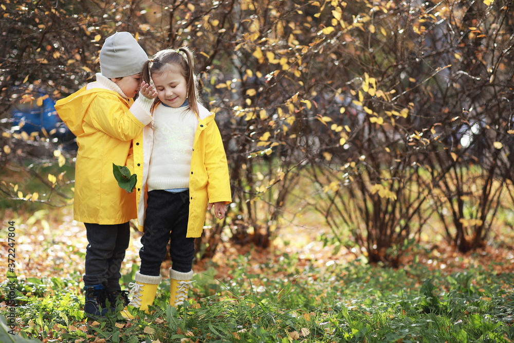 Children walk in the autumn park Children walk in the autumn park
