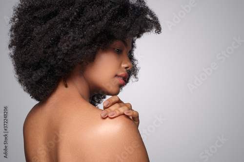 Black model touching clean shoulder