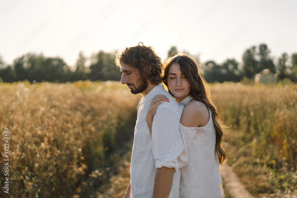 Fototapeta premium Happy summer. A loving couple together in nature. Happy vacation. Family recreation. Enjoyment and relaxation. 
