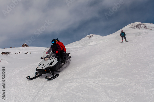 snowmobile in the mountains with people