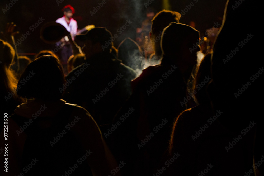 Live music concert, night life and crowd people, standing and listening music young adult people.