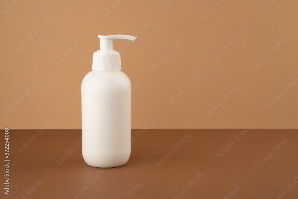 Dispenser bottle with cosmetic product on yellow background. Dispenser bottle with cosmetic product on yellow background.
