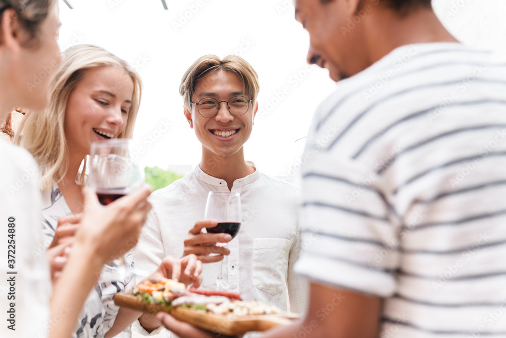 Group of happy cheerful friends having party Group of happy cheerful friends having party
