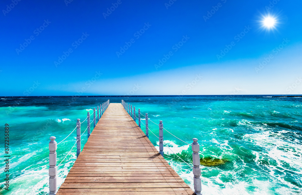 wooden bridge juts out into of the sea wooden bridge juts out into of the sea
