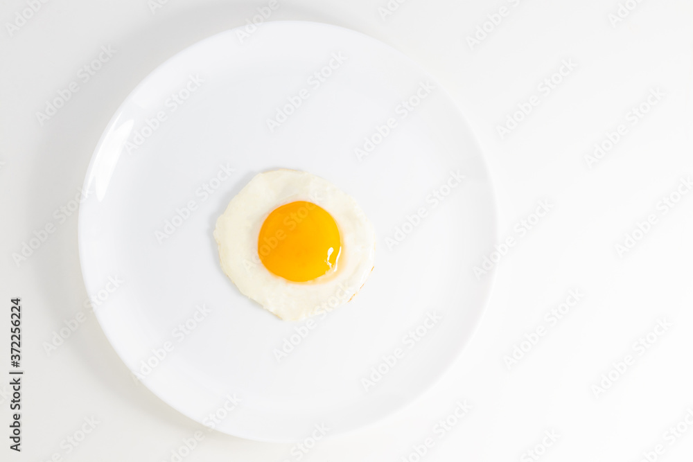 fried egg on a plate isolated on white background. Top view fried egg on a plate isolated on white background. Top view