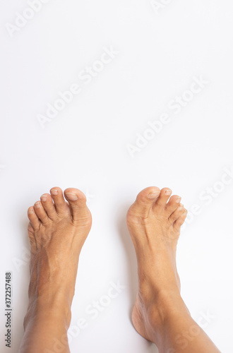 A person's bare feet on a white background