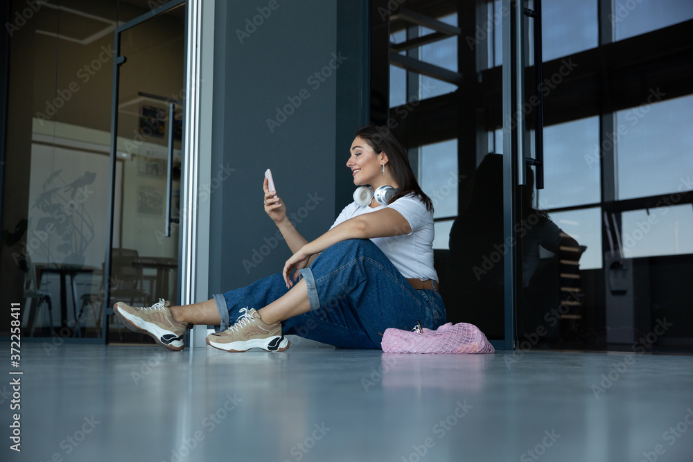 Blogging. Young woman waiting for departure in airport, traveler with small baggage, influencer's or blogger's lifestyle. Caucasian female model with gadgets before starting her vacation, registration