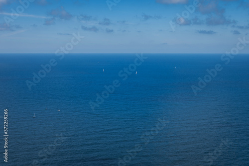 Yachts on the Atlantic ocean, deep blue water and sky.