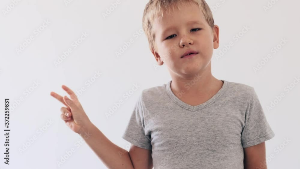 Boy waving by hand and smiling Boy waving by hand and smiling