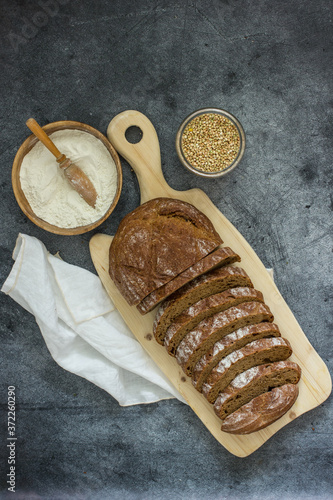 Buckwheat bread. Slices of chopped buckwheat bread on a dark background top view, food top down. Handmade Gluten Free Bread