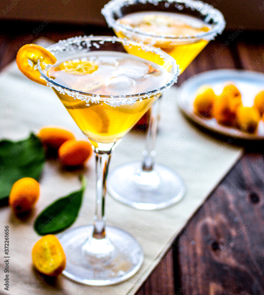 cocktail with kumquat on wooden background cocktail with kumquat on wooden background