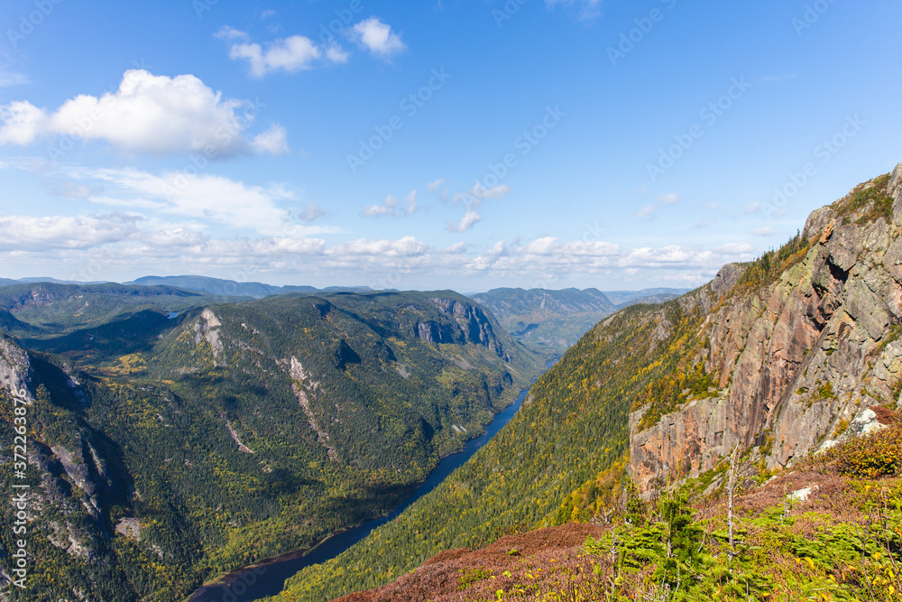 Fototapeta premium view from the top of a cliff in summer with a green valley below