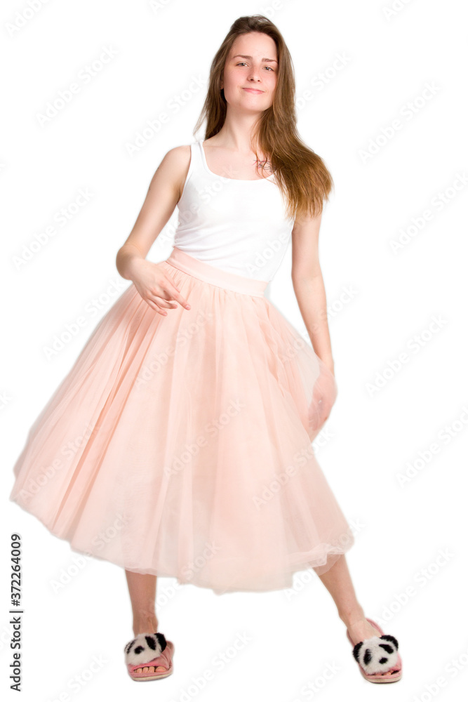 a young woman, smiling and dancing, a girl in a pink skirt and a white t-shirt.
