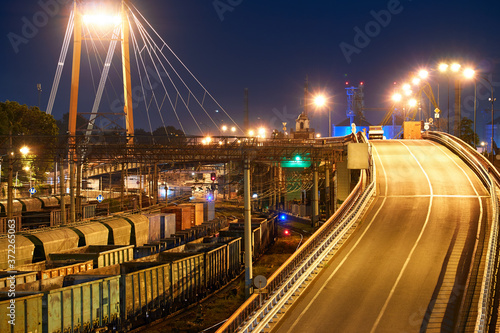 view of the industrial port in the evening - the railway and wagons deliver goods to the ships for transportation by sea