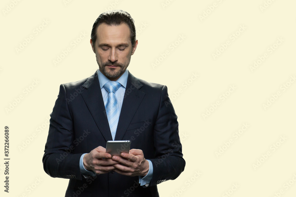 Mature businessman using smartphone on white background. Confident male executive CEO using mobile phone. People, business and lifestyle concept. Mature businessman using smartphone on white background. Confident male executive CEO using mobile phone. People, business and lifestyle concept.