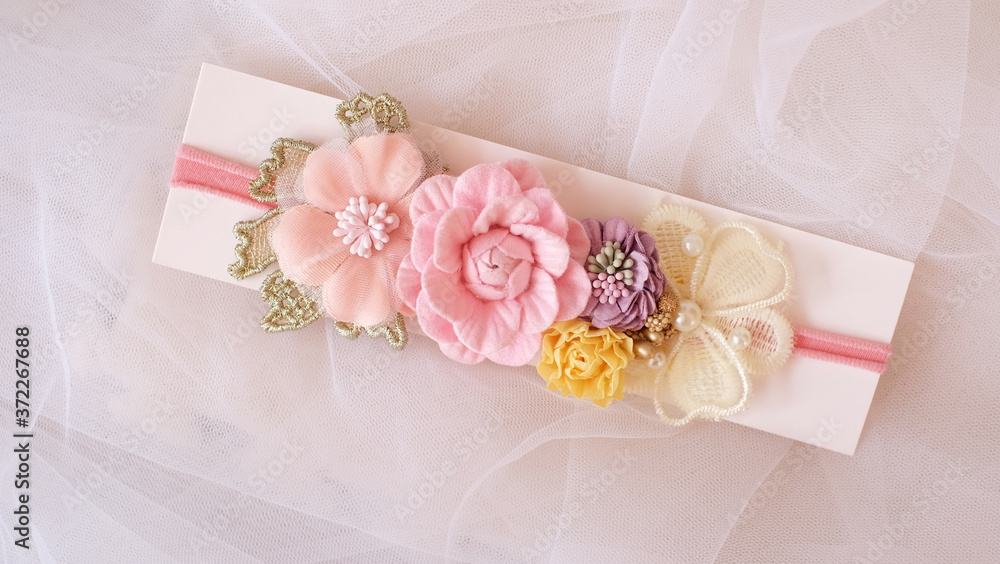 A bouquet of flowers made out of fabric cloth textile in beautiful soft pink, yellow, and violet colors placed on card stock paper that can be used as hair accessory, decoration, and embellishment A bouquet of flowers made out of fabric cloth textile in beautiful soft pink, yellow, and violet colors placed on card stock paper that can be used as hair accessory, decoration, and embellishment