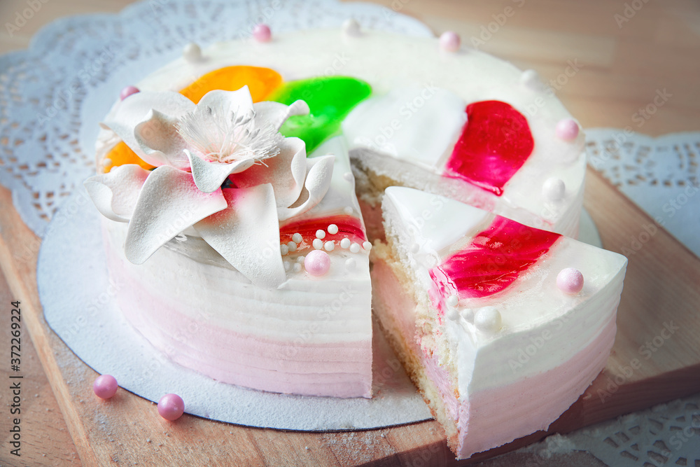 Sponge white cake with a cut piece on the table. Sponge white cake with a cut piece on the table.