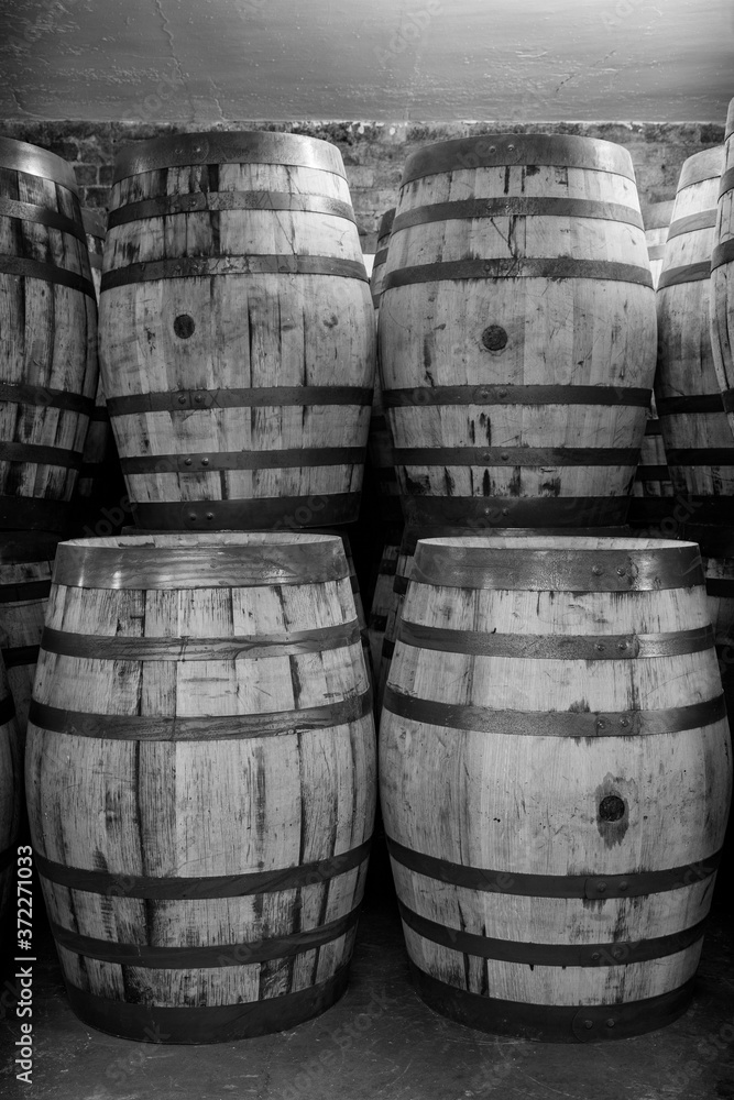 Old whisky barrels, stacked in a warehouse ready to fill with raw spirit and leave to mature over time Old whisky barrels, stacked in a warehouse ready to fill with raw spirit and leave to mature over time