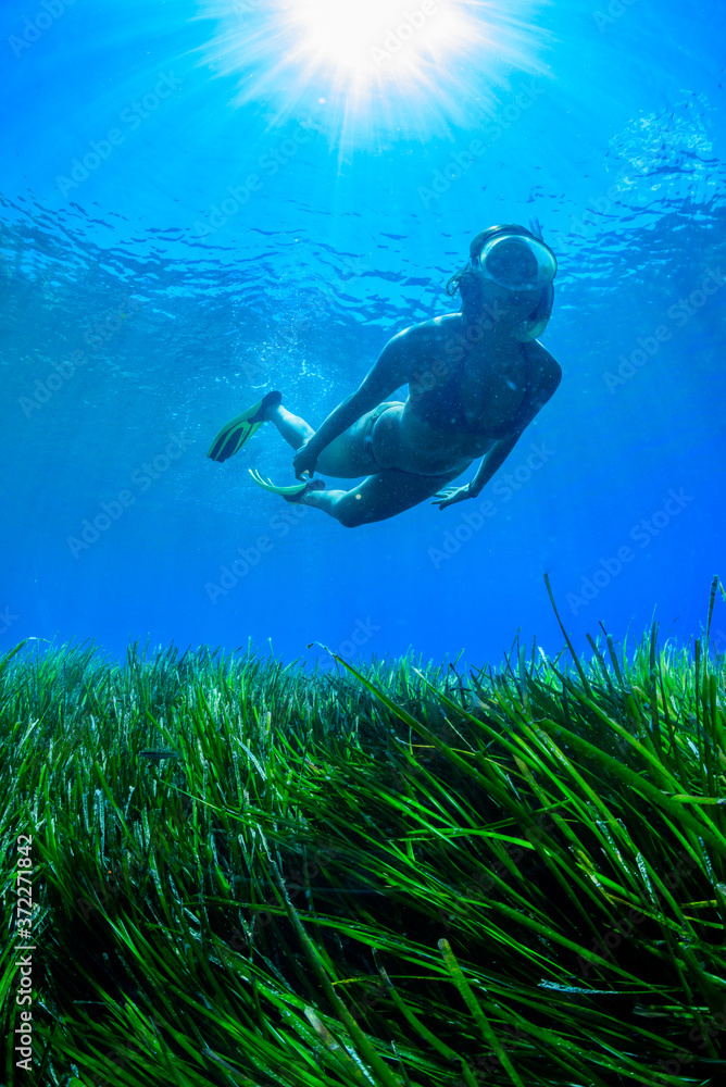 A young woman is diving