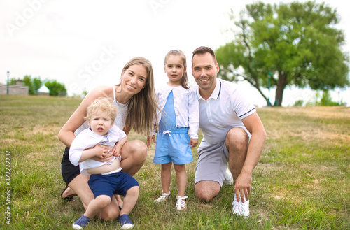 Happy young family outside in summer day
