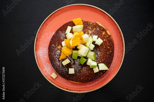 waffle with fruits on black wood background