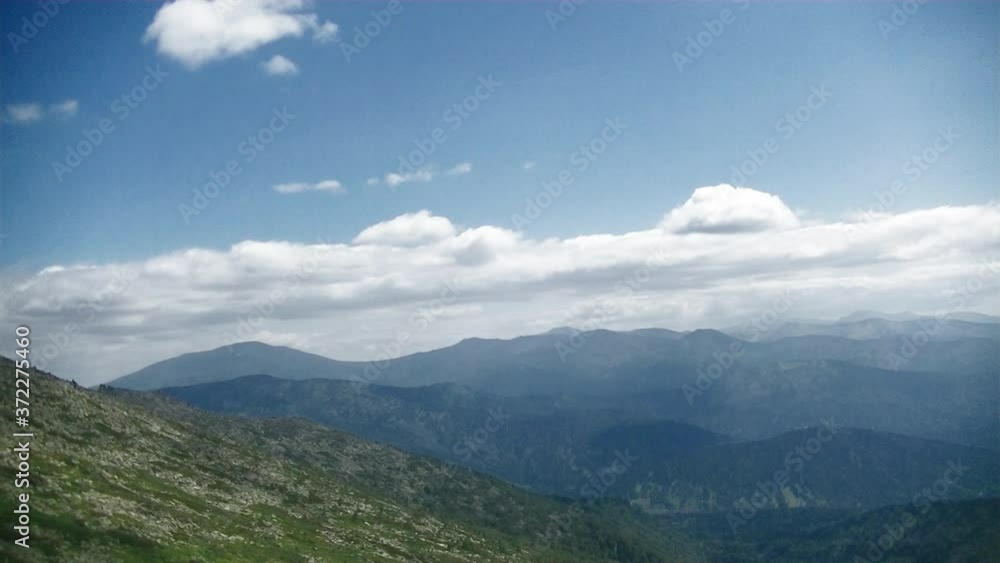 Cumulus and rain clouds over the tops of high mountains Cumulus and rain clouds over the tops of high mountains