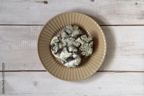 Freshly baked chocolate crinkles on a plate on a wooden table