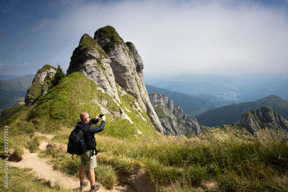 Young hiker backpacker in romanian Ciucas mountains.
