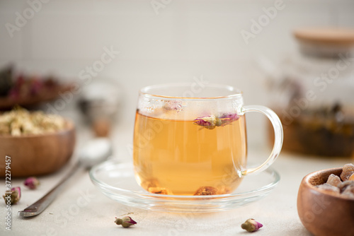 hot green tea with roses in a glass cup