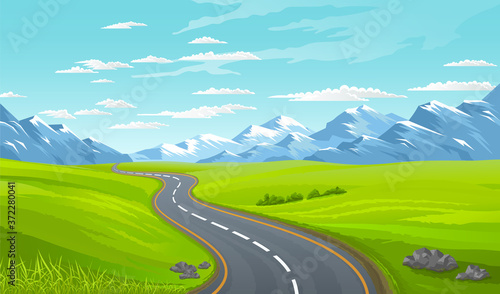 Asphalt road at green summer lawn or meadow. View at beautiful summer landscape with snowy mountains and blue clouded sky at background. Traveling time. Calm scenery, road to mountains, summer