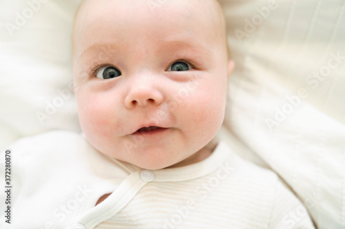 cute two month old baby in bed at home