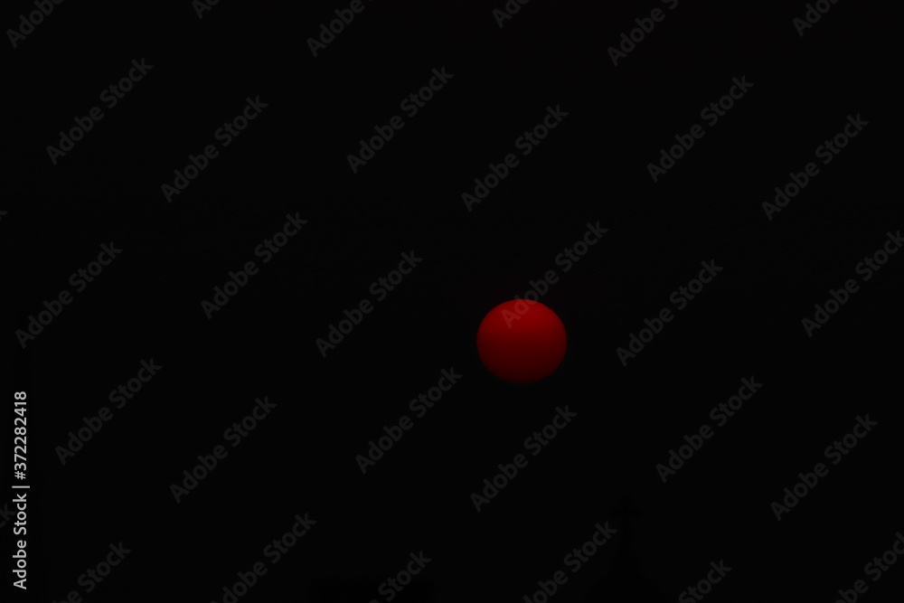 red sphere in the dark red sphere in the dark