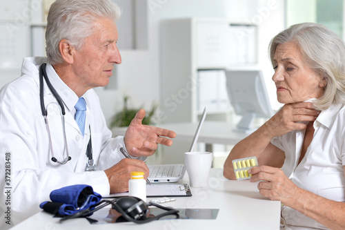 Close up portrait of senior doctor with a elderly patient