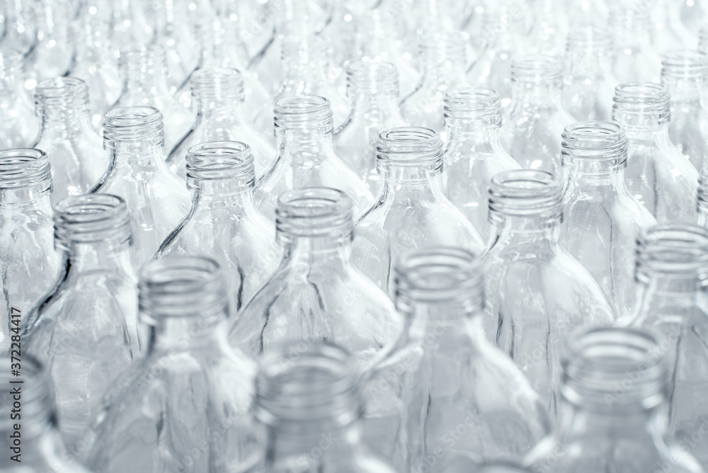 Pattern of transparent glass bottles in a row Pattern of transparent glass bottles in a row