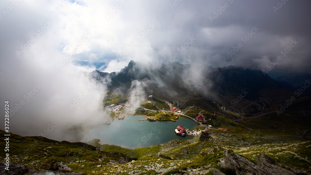 Fototapeta premium alea Lake covered by fog, Fagaras Mountains, Romania in the summer.