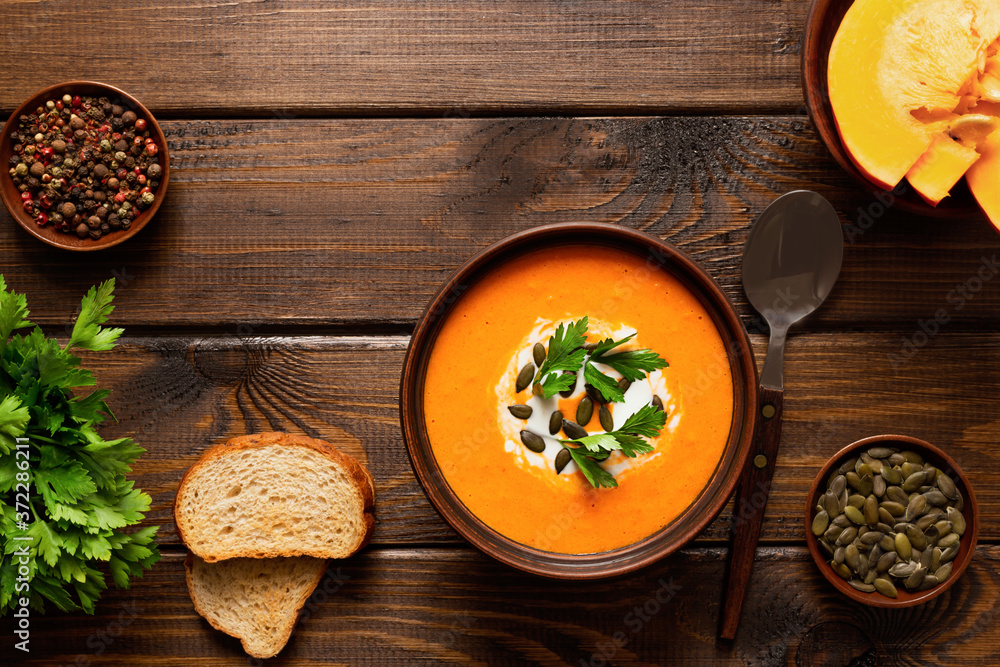 Pumpkin cream soup, served with crackers and parsley. Diet food concept. Vegetarian and vegan food. Healthy eating Pumpkin cream soup, served with crackers and parsley. Diet food concept. Vegetarian and vegan food. Healthy eating