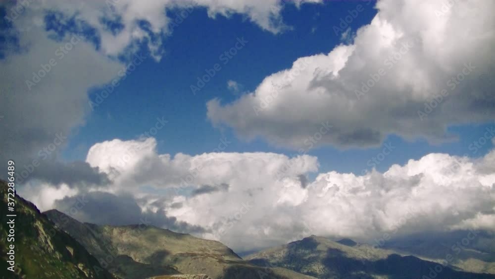 Cumulus and rain clouds over the tops of high mountains Cumulus and rain clouds over the tops of high mountains