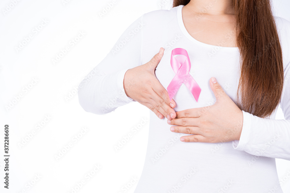 Breast cancer awareness ribbon on woman chest and doing self exam isolated over white background. Medical, healthcare for advertising concept. Breast cancer awareness ribbon on woman chest and doing self exam isolated over white background. Medical, healthcare for advertising concept.