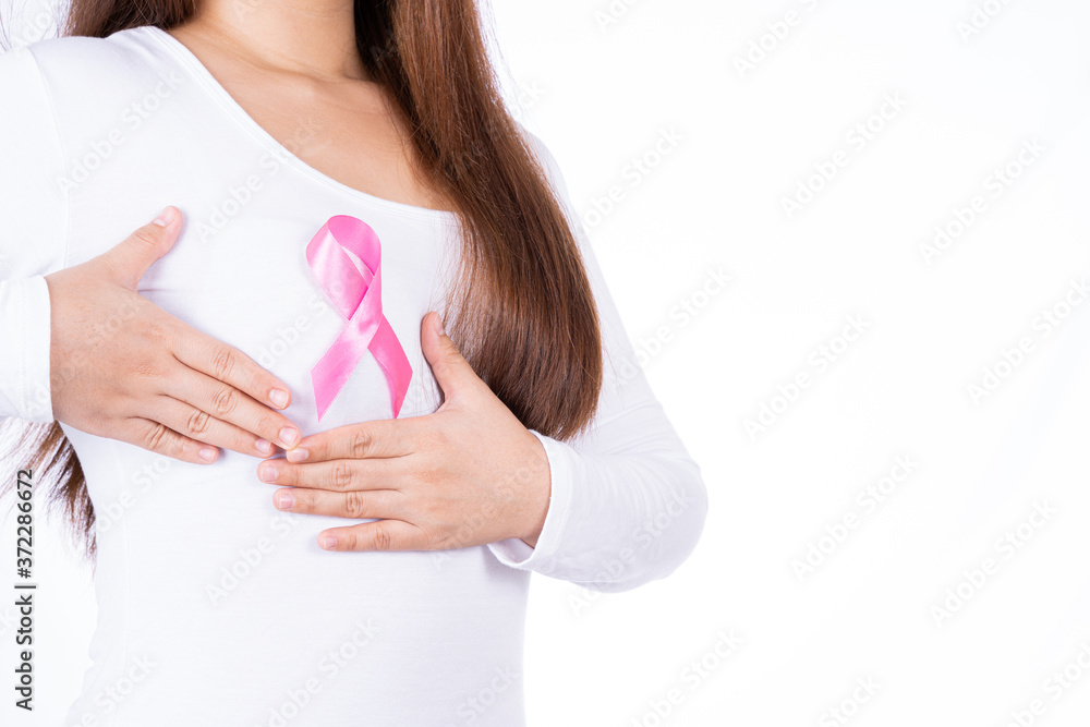 Breast cancer awareness ribbon on woman chest and doing self exam isolated over white background. Medical, healthcare for advertising concept. Breast cancer awareness ribbon on woman chest and doing self exam isolated over white background. Medical, healthcare for advertising concept.