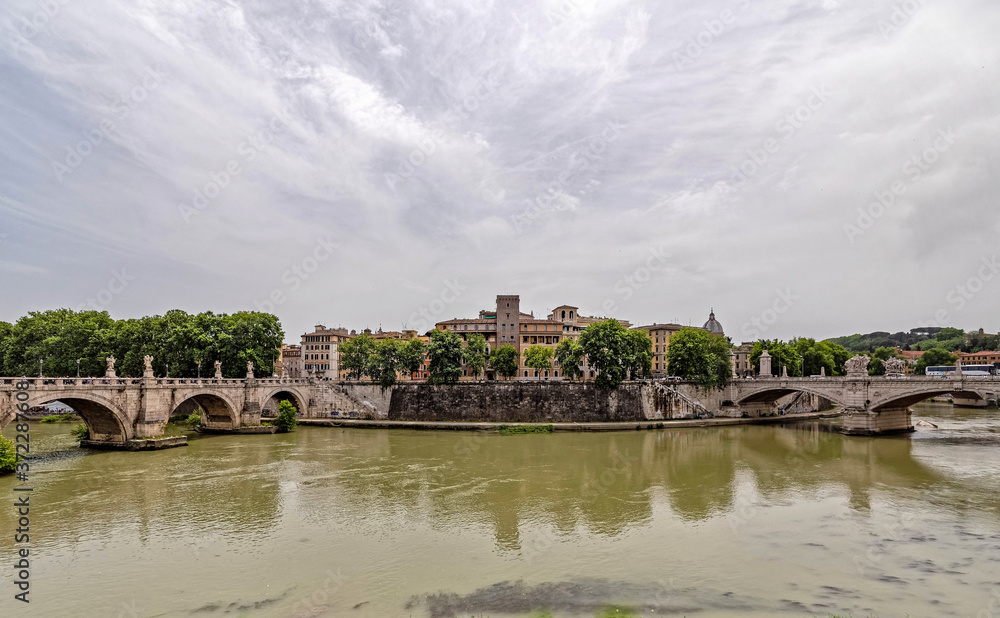 Rome Italy, Saint Angelo and Vittorio Emanuele II bridges on Tiber river panoramic view under impressive sky
