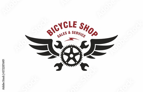 Color illustration of crossed wrenches, wings, bicycle gear, red text on a white background. Vector illustration advertises the sale and service of bicycles. Bicycle shop logo.
