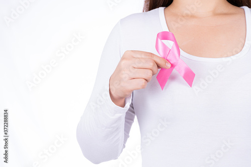 Breast cancer awareness ribbon on woman chest isolated over white background. Medical, healthcare for advertising concept.