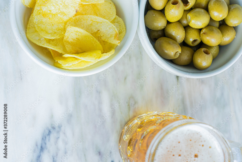 Beer with chips and olives Beer with chips and olives